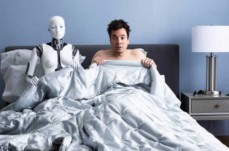 Surprised man sitting in bed next to a robot
