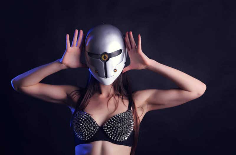 Woman in a black bra with a silver helmet on a black background