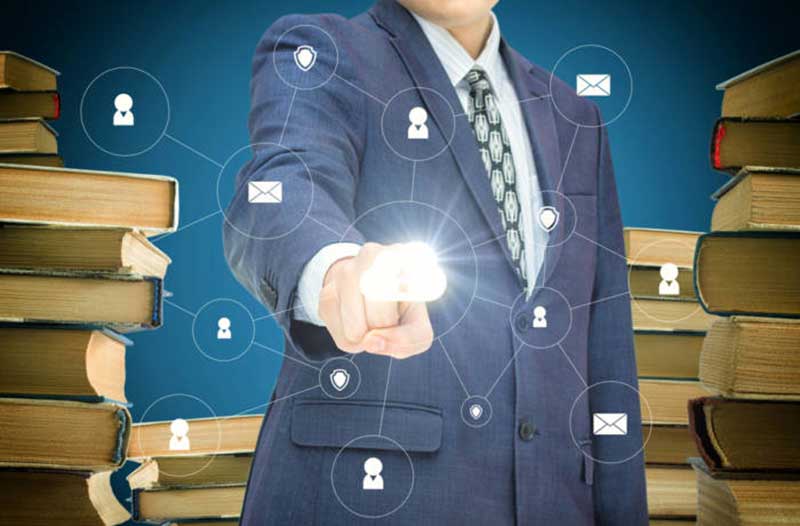 A person in a suit pointing at a glowing symbol of the cloud, with symbols of people and messages surrounding it