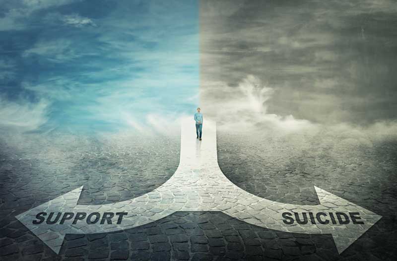 Blue sky and grey sky with arrow pointing to ‘support’ and ‘suicide’