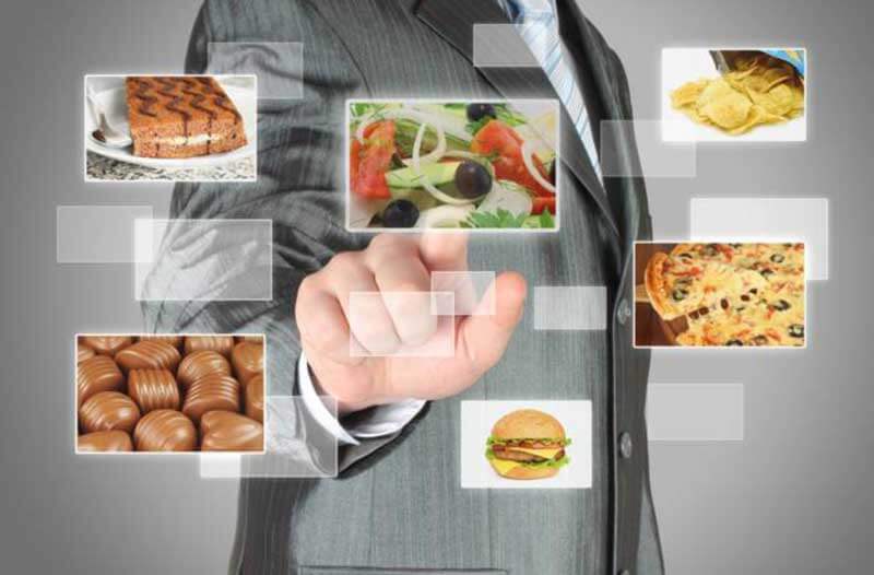 a person in a suit interacting with a digital interface featuring images of food