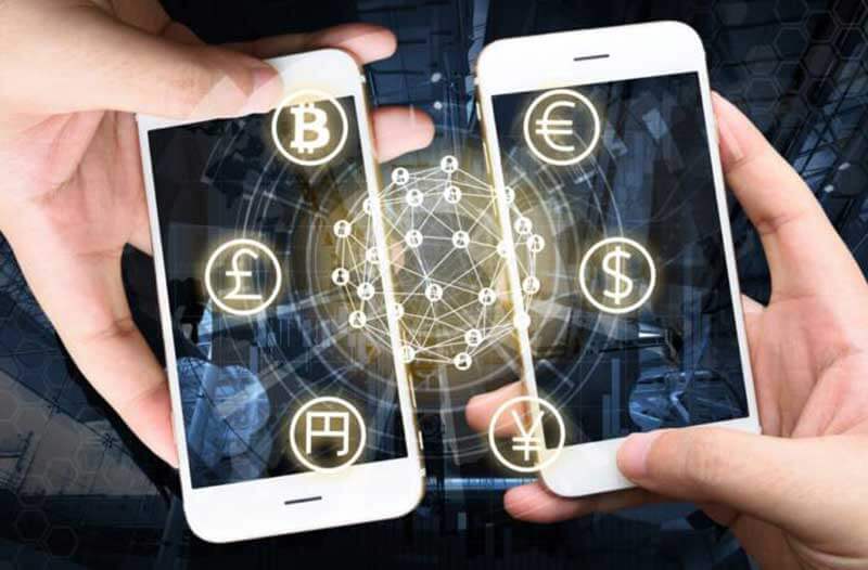 Two hands holding two smartphones with currency icons floating above their displays