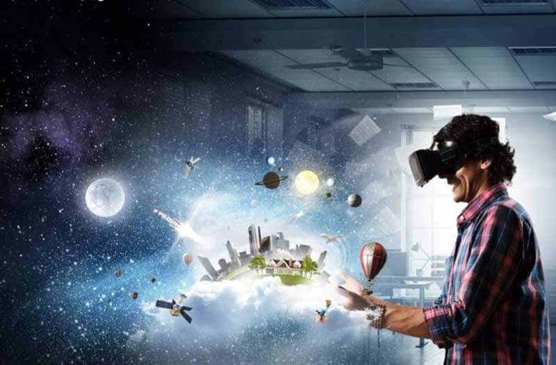 A man wearing a VR headset looking towards a digital illustration of a city skyline with planets and satellites